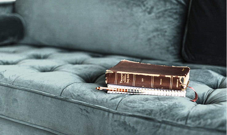 A Bible on the couch to represent the tools for a winning prayer meeting.
