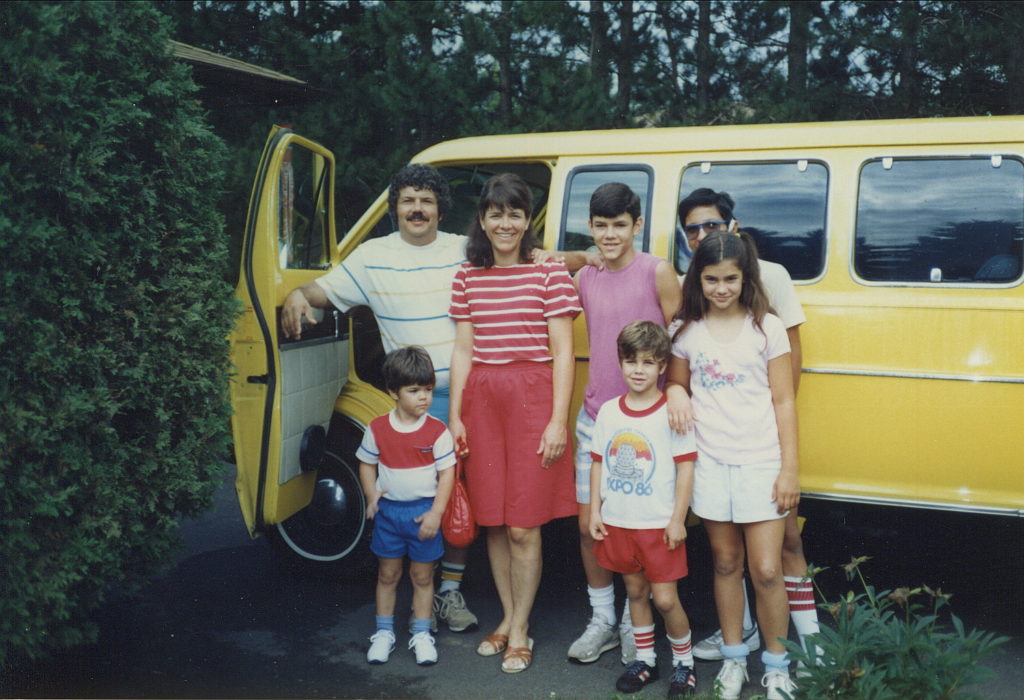 The Reginelli Family standing with the Glory Van- an answer to their family prayers.